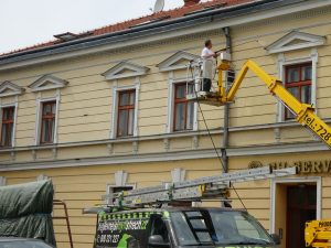 Mytí fasády staršího domu z výškové plošiny.